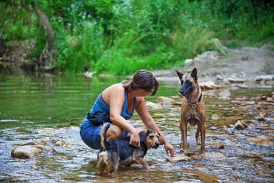 Woman with dogs in river