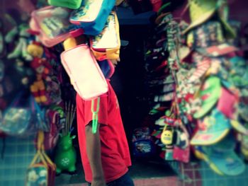 Low section of man standing against multi colored background