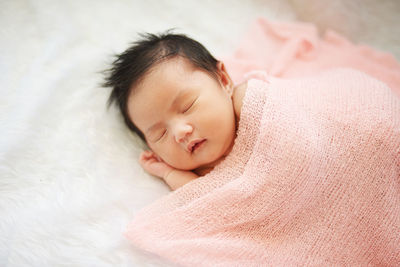 Cute baby sleeping on bed