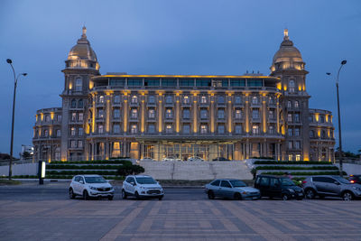 Cars parked on street against building