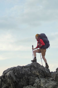 Man standing on rock against mountain