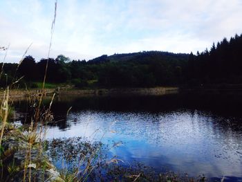 Calm lake with mountain range in background