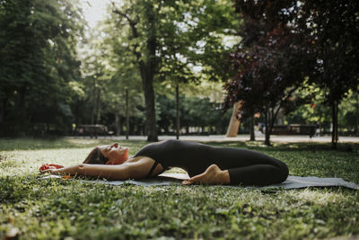 Fitness instructor doing yoga in park
