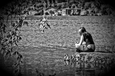 Rear view of woman looking at lake