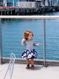 Full length of girl standing in swimming pool