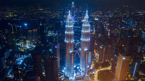 High angle view of illuminated city buildings at night