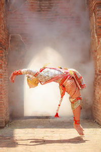 Male dancer wearing traditional clothing while performing on stage