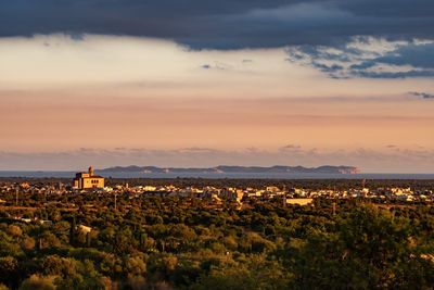 Scenic view of buildings against sky during sunset