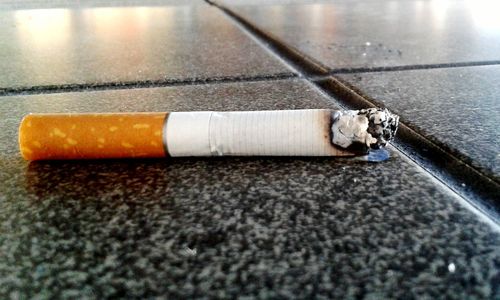High angle view of cigarette on floor