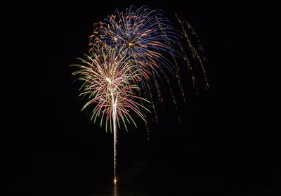 Low angle view of firework display at night