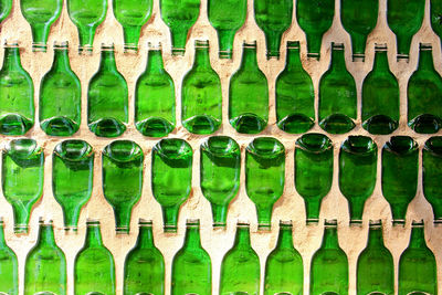 Full frame shot of green bottles art on wall