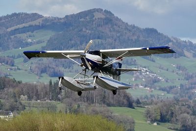 Close-up of airplane wing. seaplane taking off in the mountains. 