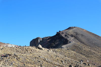 Scenic view of rocky mountains against clear blue sky