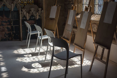 Empty chairs and table in building