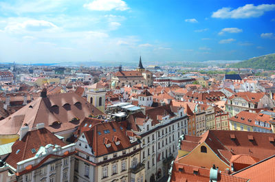 View of cityscape against cloudy sky