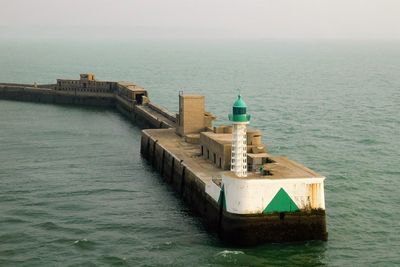 Scenic view of sea and lighthouse  against clear sky in zeebrugge, belgium