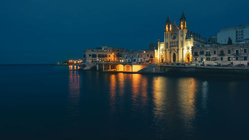 Illuminated buildings at waterfront