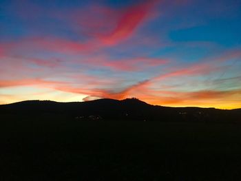 Scenic view of silhouette mountains against sky during sunset