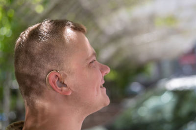 Close-up of a hearing aid on a man's ear