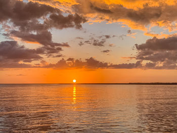 Scenic view of sea against romantic sky at sunset