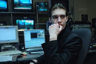 Businessman looking away while sitting at office