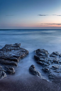 Scenic view of sea against sky at sunset