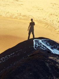 Silhouette man on sand at beach