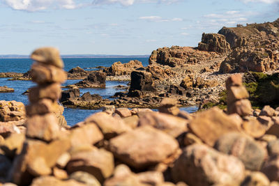 Rocks on beach against sky