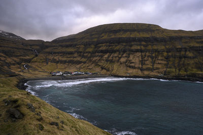 Scenic view of sea and mountains against sky