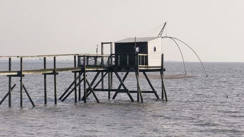 Pier over sea against clear sky