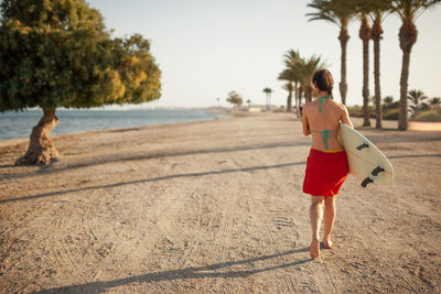 Full length of woman running on beach