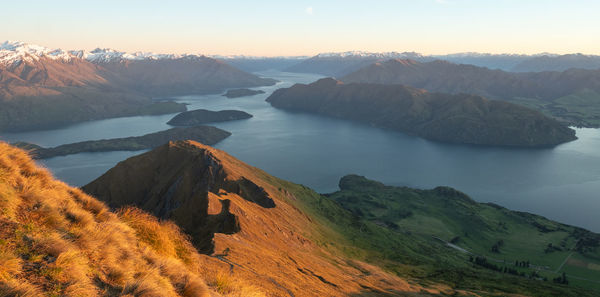 View on lake from mountain summit during sunrise, shot made on roys peak in wanaka, new zealand