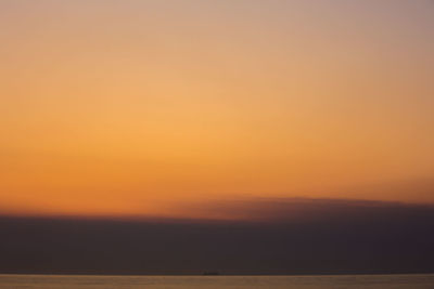 Scenic view of sea against orange sky