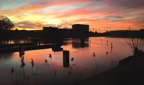 Scenic view of lake against orange sky
