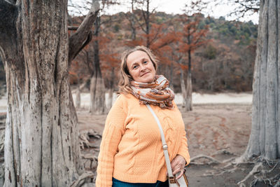 Portrait of a smiling young woman standing in park