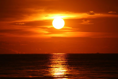 Scenic view of sea against romantic sky at sunset