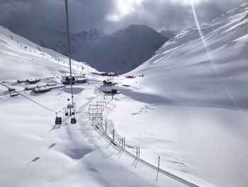 Ski lift over snowcapped mountains