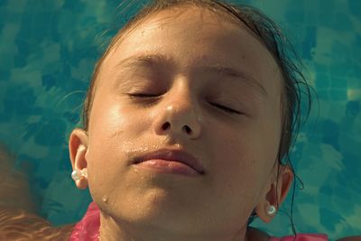 Close-up portrait of girl with swimming pool