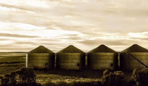 Barn on field against sky