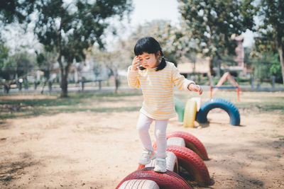 Side view of young woman sitting on field