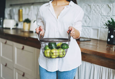 Midsection of woman holding food at home