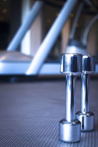 Close-up of dumbbells on floor at gym