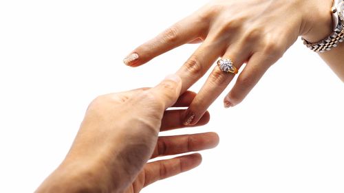 Close-up of hands over white background