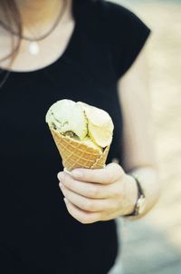 Close-up of hand holding ice cream cone