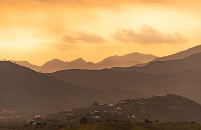 Scenic view of silhouette mountains against sky during sunset