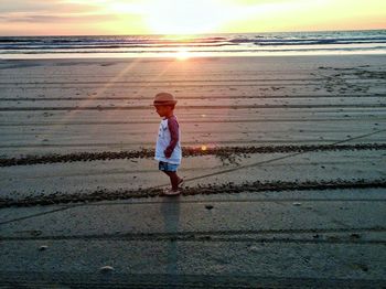 Full length of girl at beach during sunset