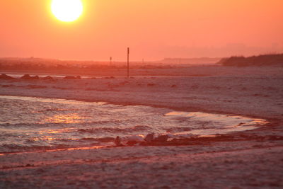 Scenic view of beach against sky during sunset