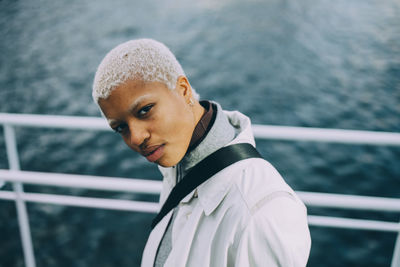 Portrait of contemplating young female standing in ship