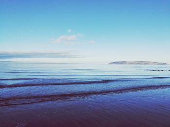 Scenic view of sea against blue sky