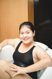 Portrait of young woman sitting at home